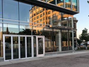 Wonderstate Coffee glass storefront with reflective windows, front door and interior wooden seating